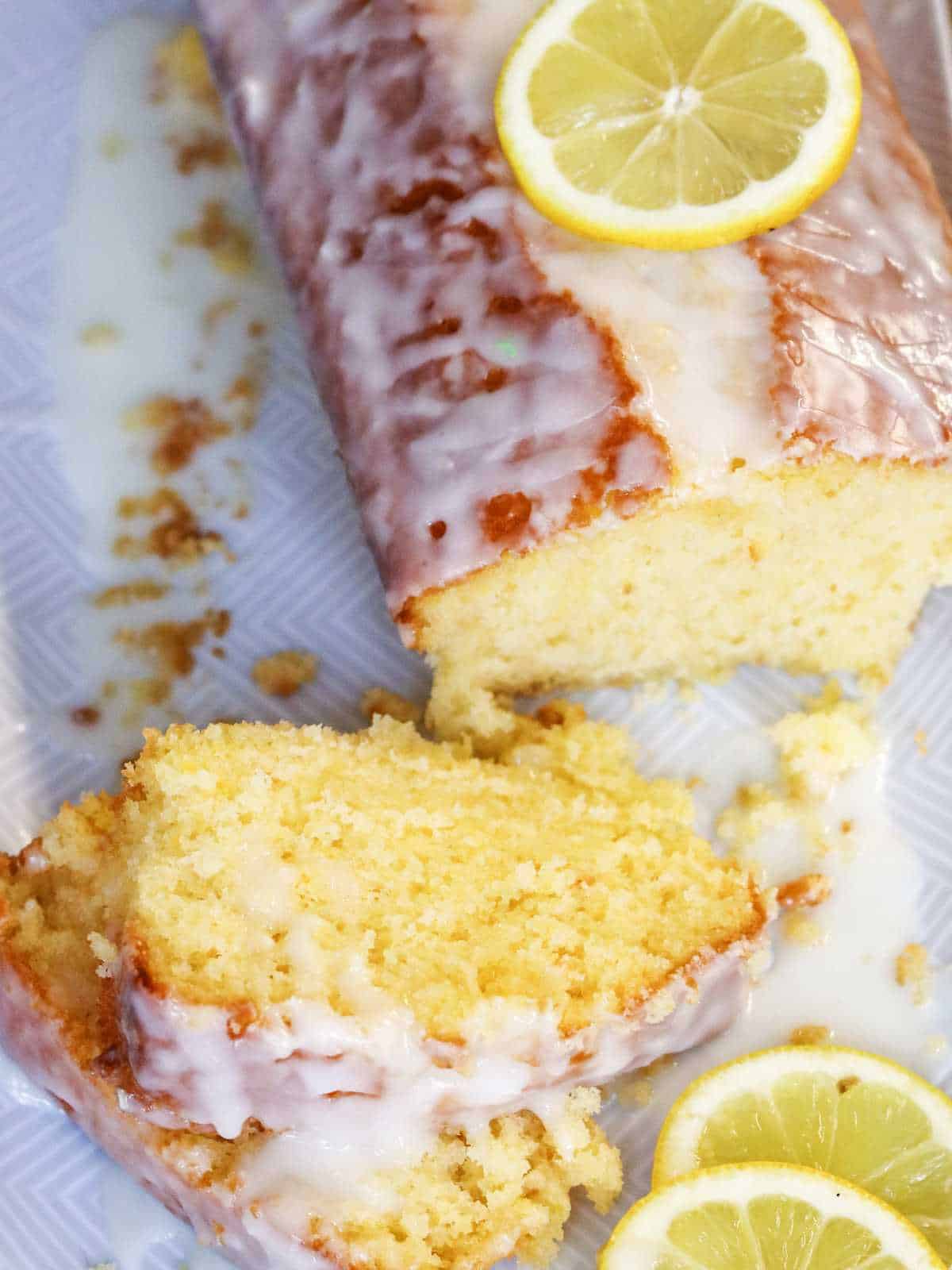 lemon loaf cake with icing drizzled on top.
