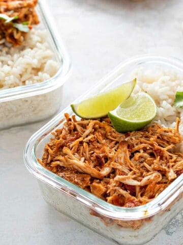 Meal prep containers with pulled chicken with salsa and rice, mexican cuisine.