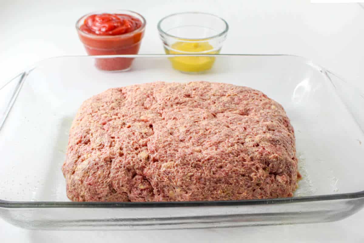 meat mixture formed into a loaf and set in a baking pan for southern meatloaf recipe.