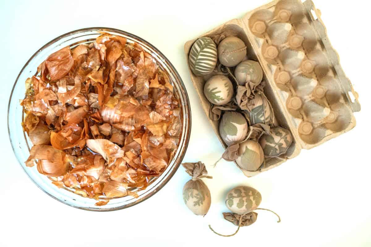 eggs wrapped with herbs and ready to get dyed with onion skins.