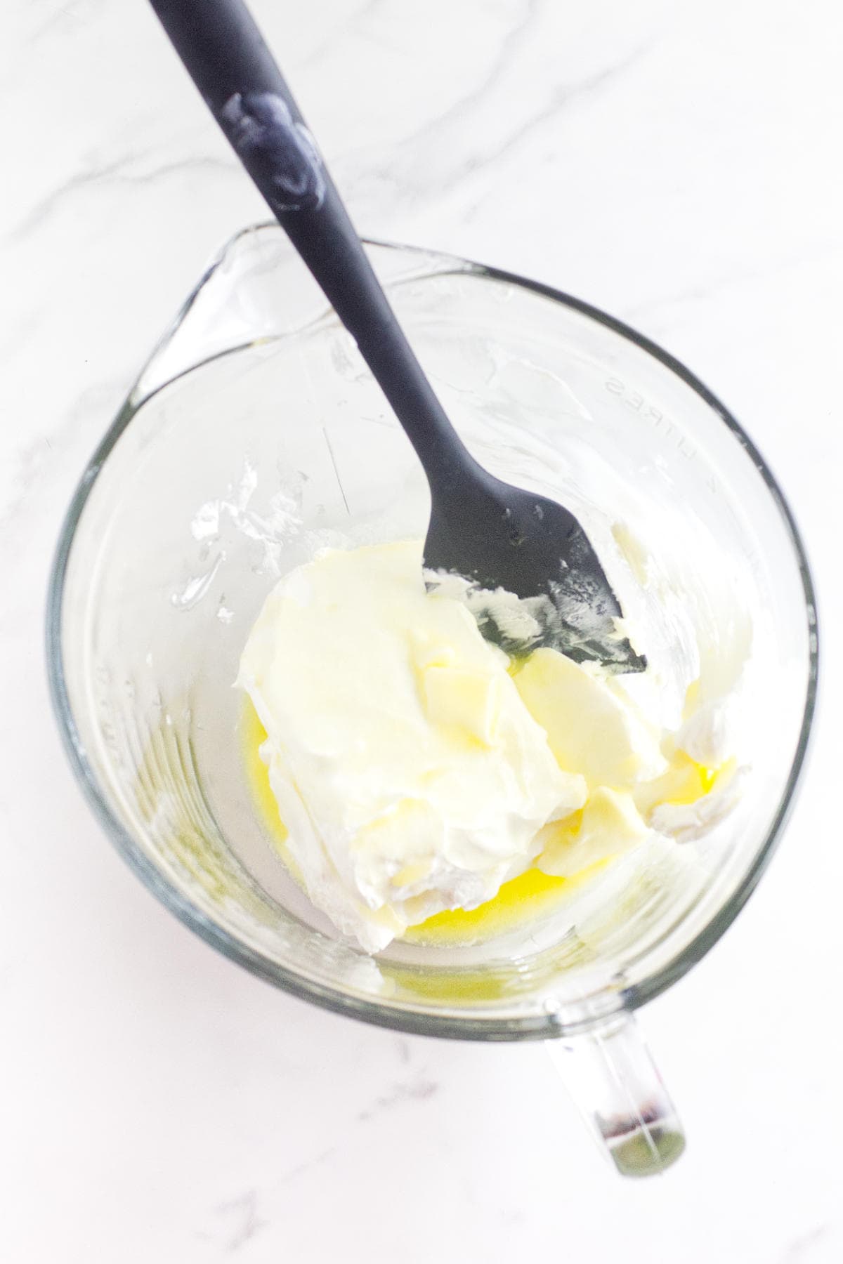 Cream cheese and butter in a mixing bowl.