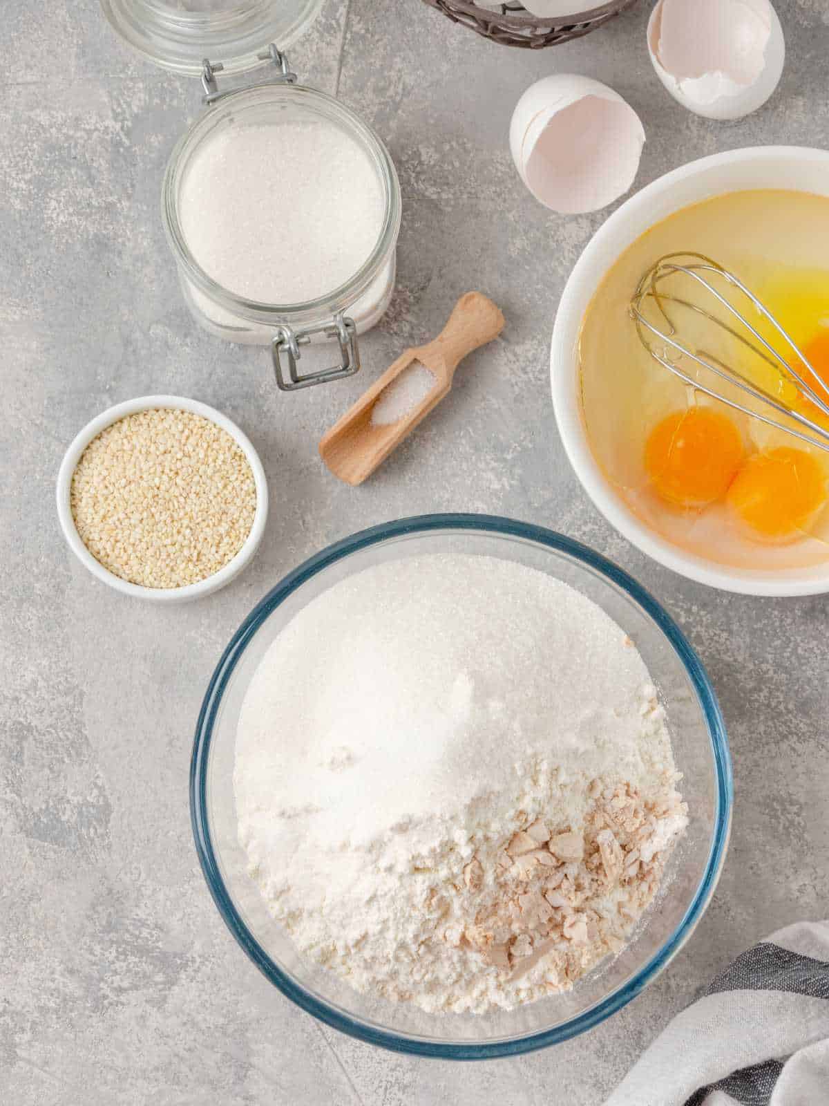 Yeast, flour, eggs, milk on a gray concrete background.