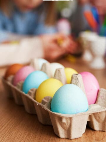 Close up of a family dying and decorating Easter eggs.