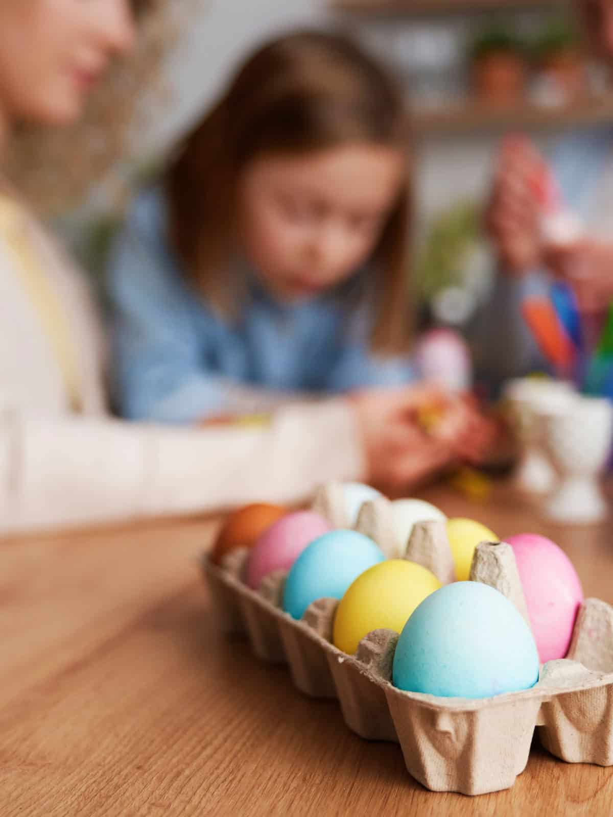Close up of a family dying and decorating Easter eggs.