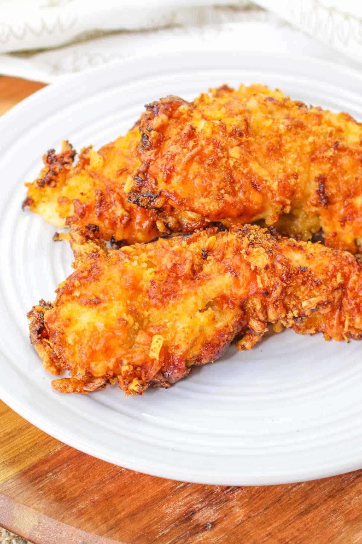 crispy air fried chicken breast on a serving plate.