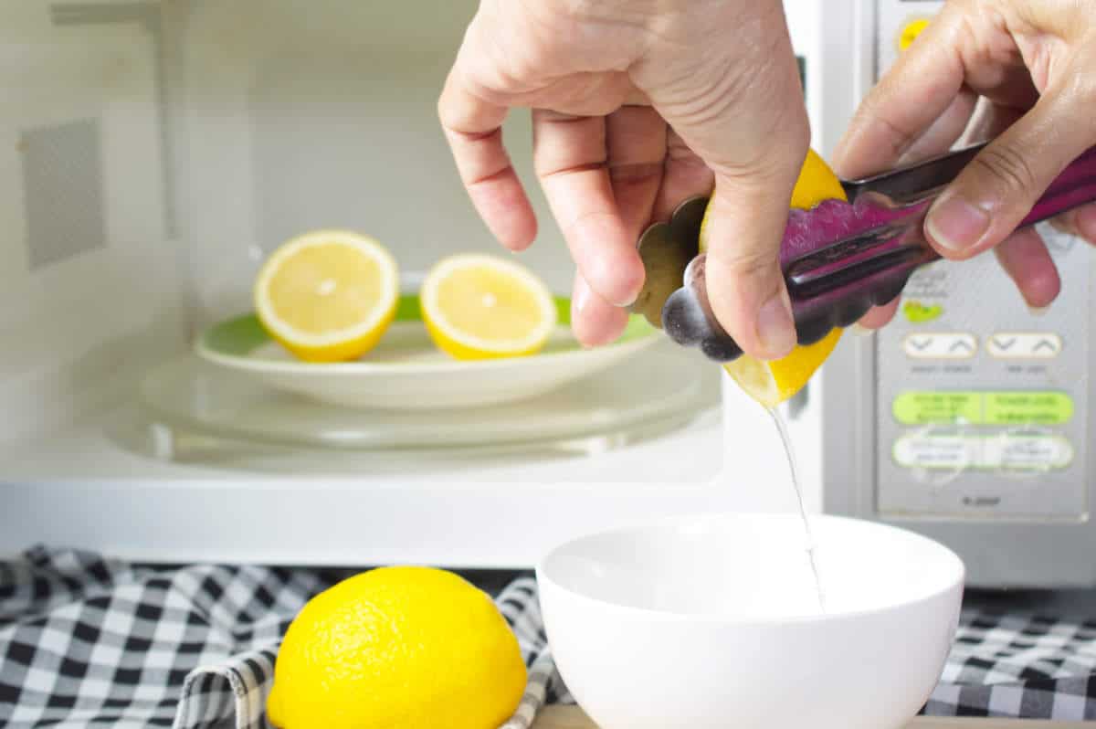 microwaving lemons for 20 - 30 seconds before squeeze make them soft and easily squeeze; use kitchen tongs help to squeeze.tongs.