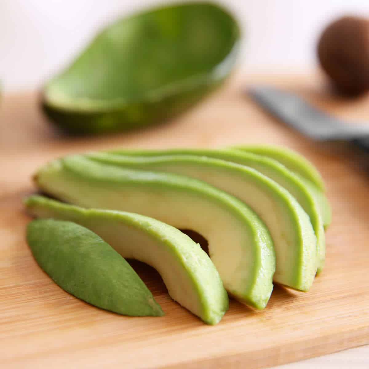 Fresh sliced avocado on cutting board.