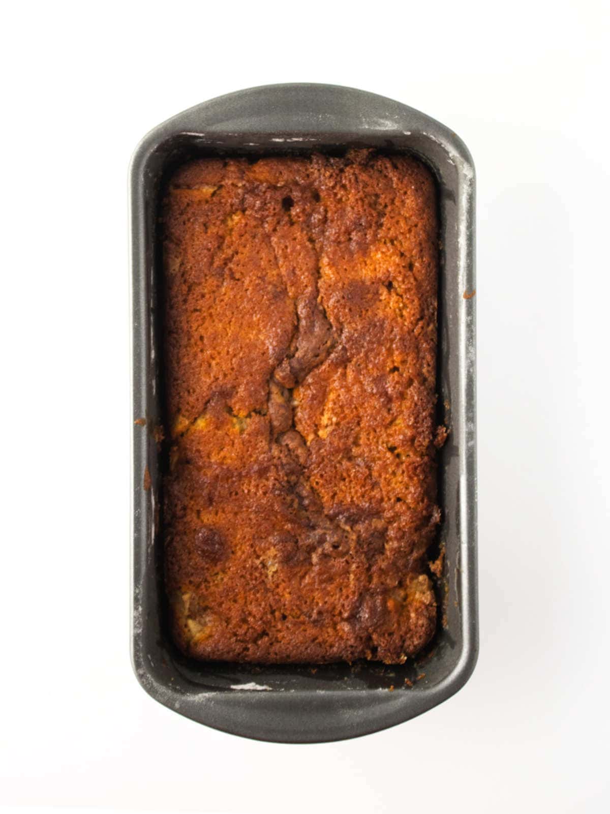 baked apple cake in a loaf cake pan.