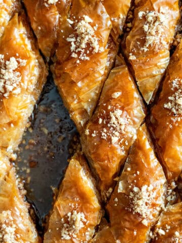 Classic walnut baklava cut into diamond shapes in a baking pan.