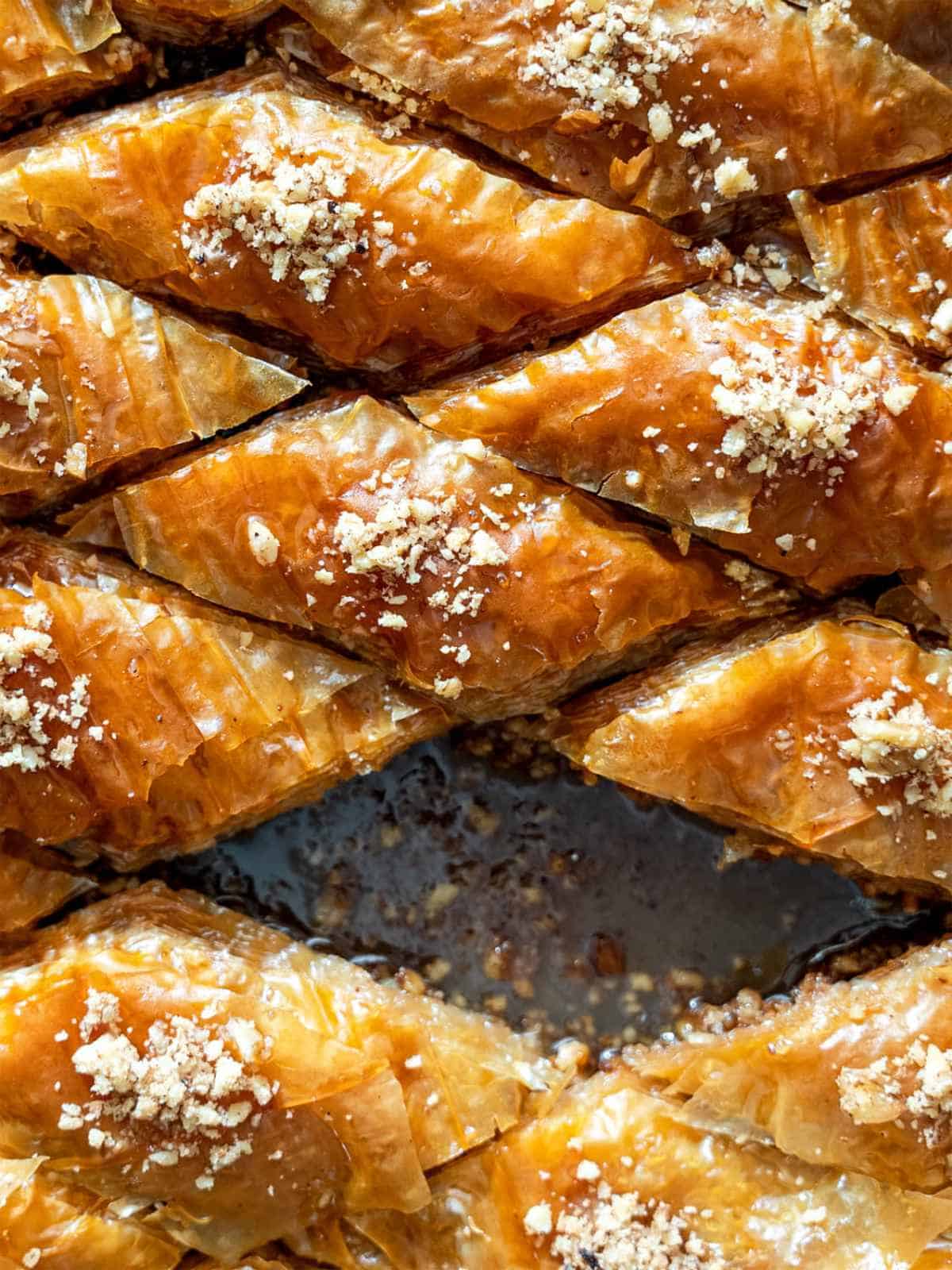 Classic walnut baklava cut into diamond shapes in a baking pan.