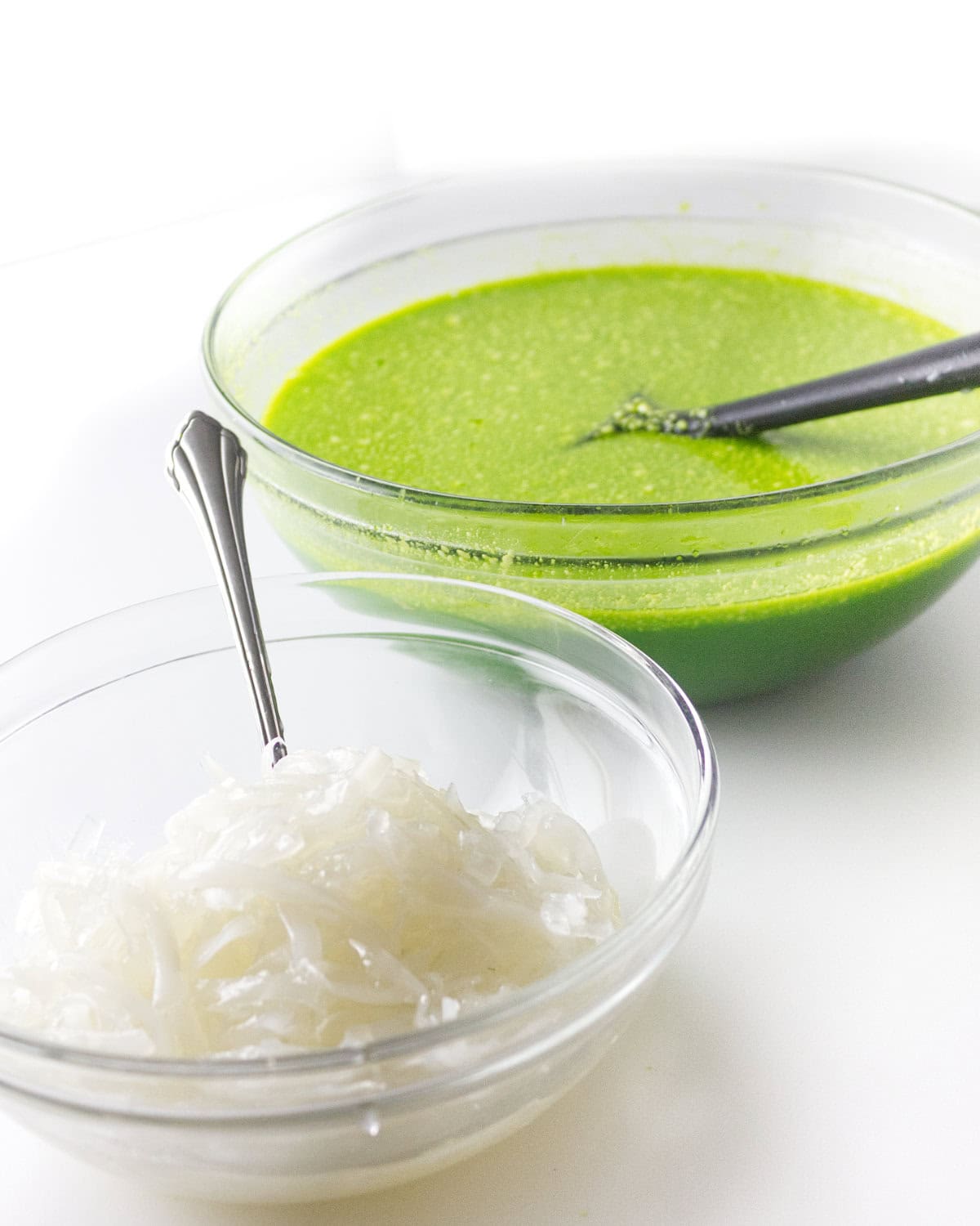 bowl of lime green jello mixture and a bowl of sport coconut.