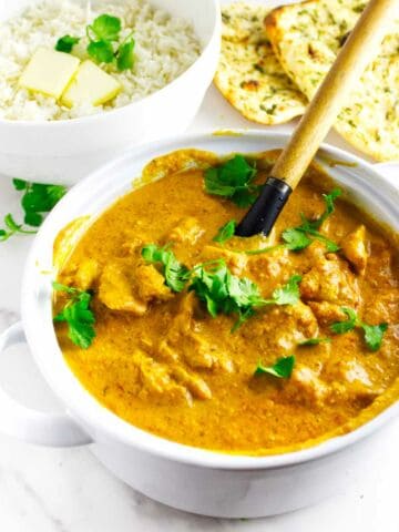 Butter chicken with naan bread and buttered rice.