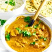 Butter chicken with naan bread and buttered rice.