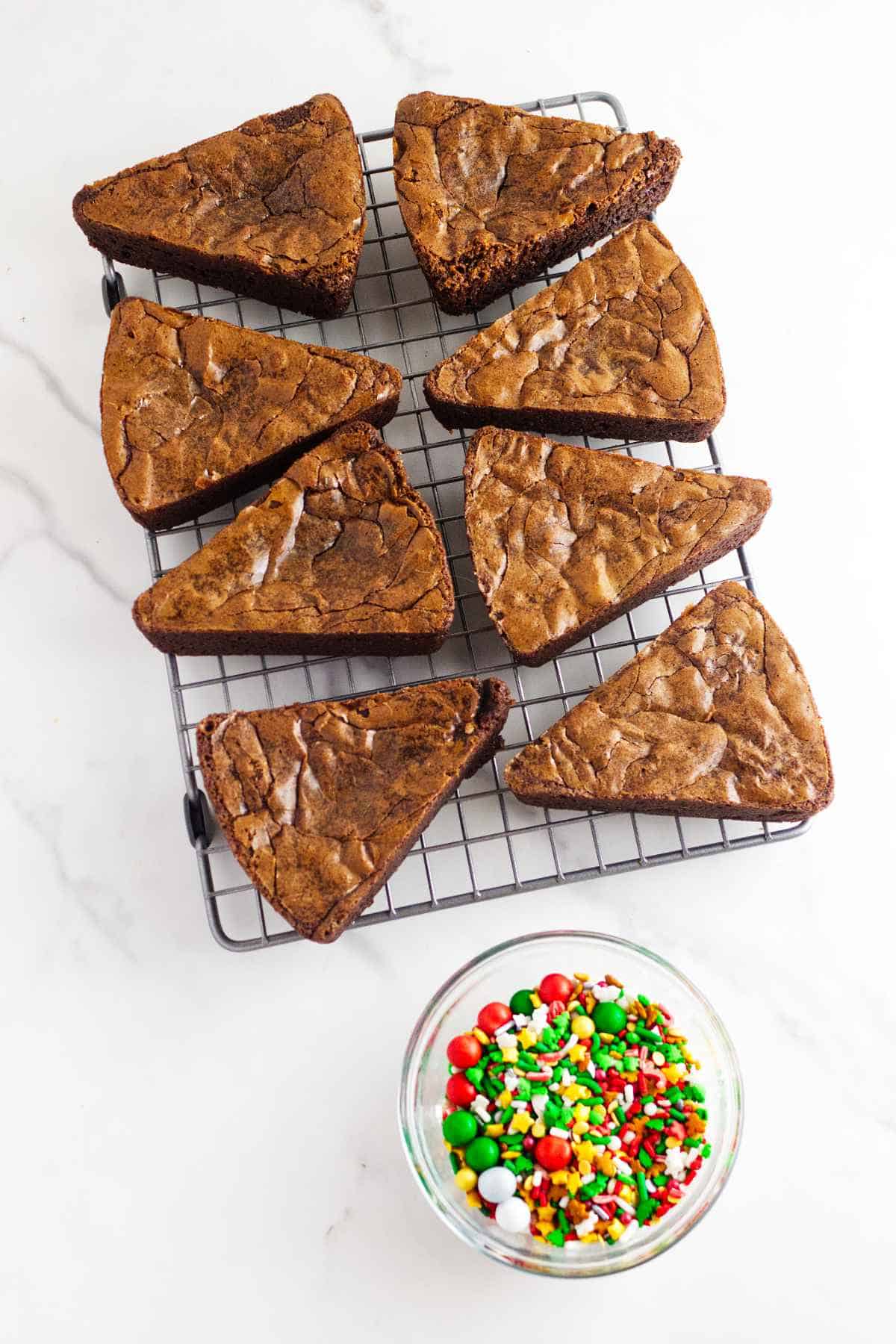 Christmas tree brownies on a cooling rack.