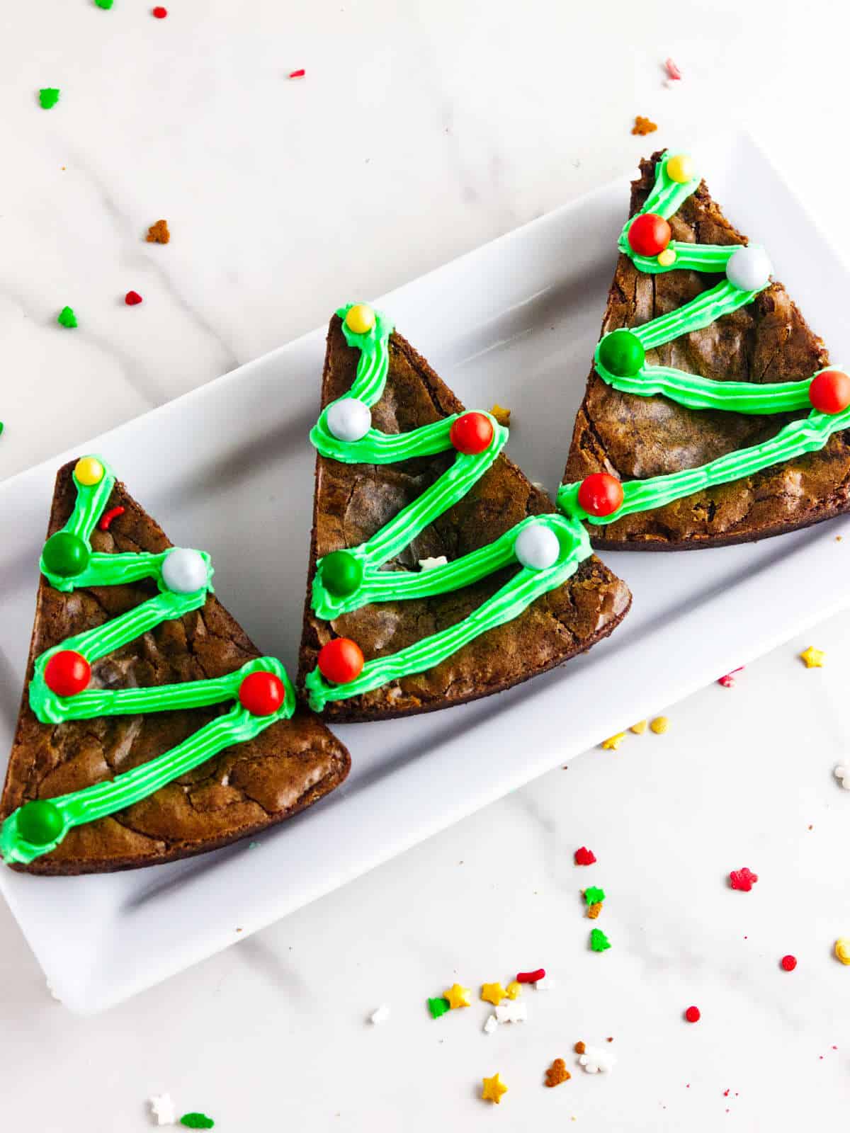 Christmas tree brownies on a serving platter.