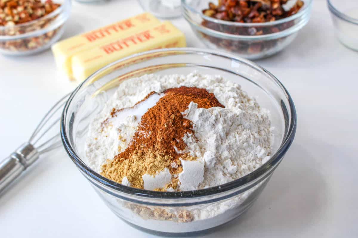 Flour and spices get whisked together to fully blend.