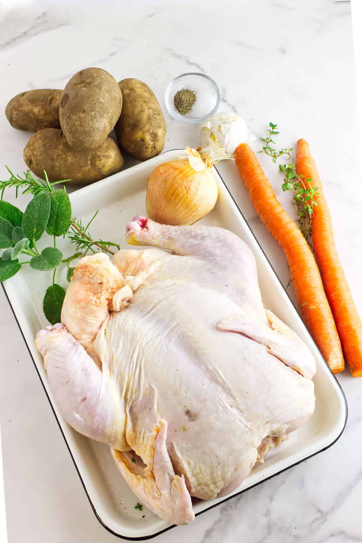 Large chicken, potatoes, carrots, onion, and aromatic herbs.