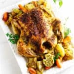 oven roasted chicken with potatoes and carrots on a platter.