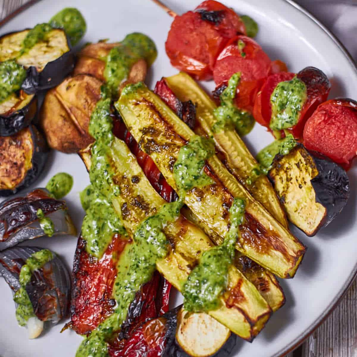 grilled tomatoes, eggplant, and zucchini on a platter.