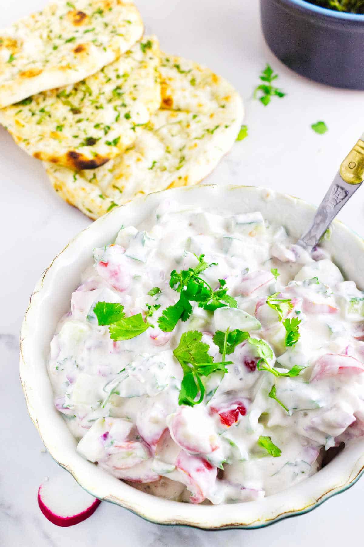 Indian cucumber and yogurt salad with naan bread.