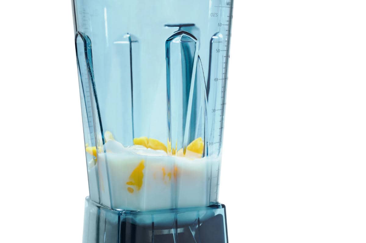 Mango and yogurt smoothie. Smoothie in blender with white background top view. Ingredients such as: mango, yogurt.