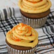 peanut butter cupcakes with peanut butter frosting decorated with orange sugar.