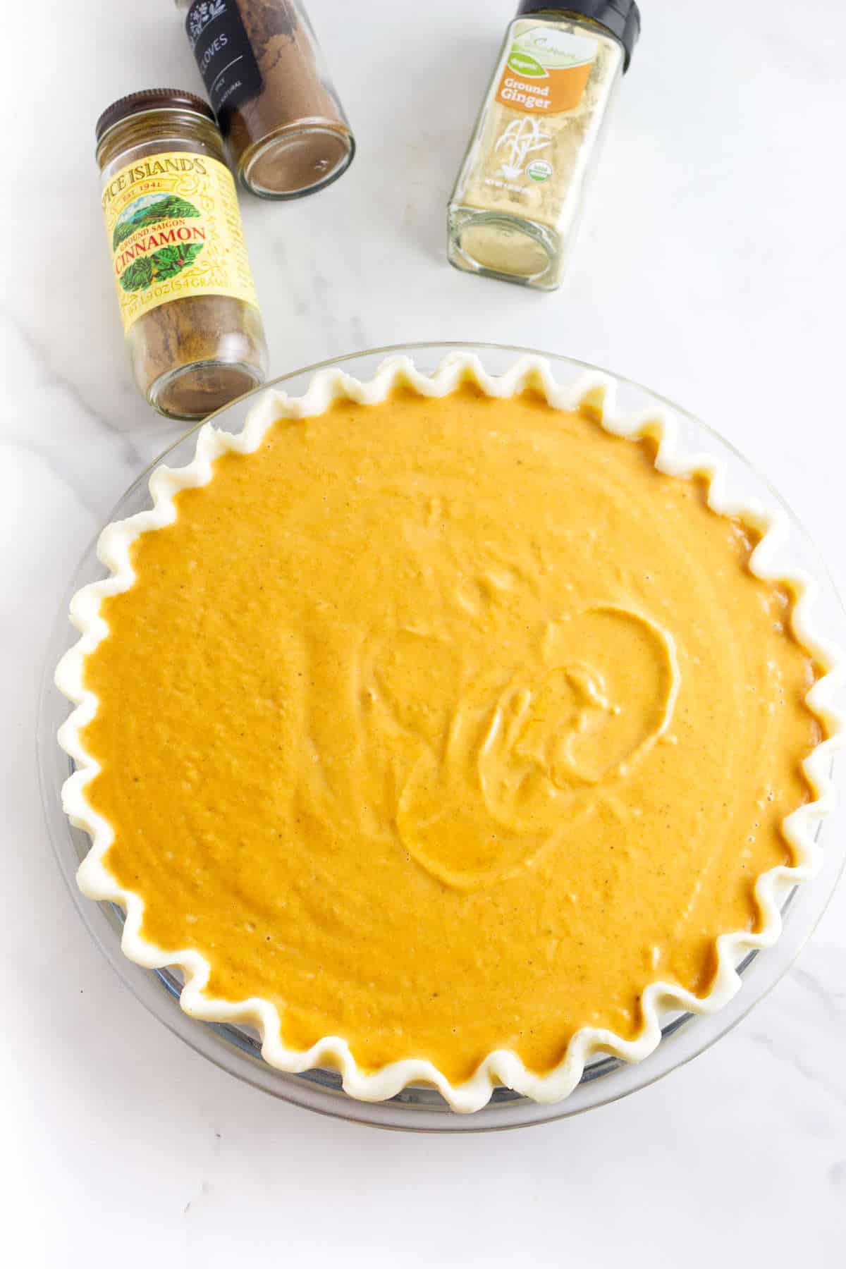 pumpkin pie filling without evaporated milk or condensed milk in a pie shell ready to bake.