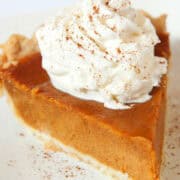 pumpkin pie without evaporated milk with whipped cream and cinnamon on top.