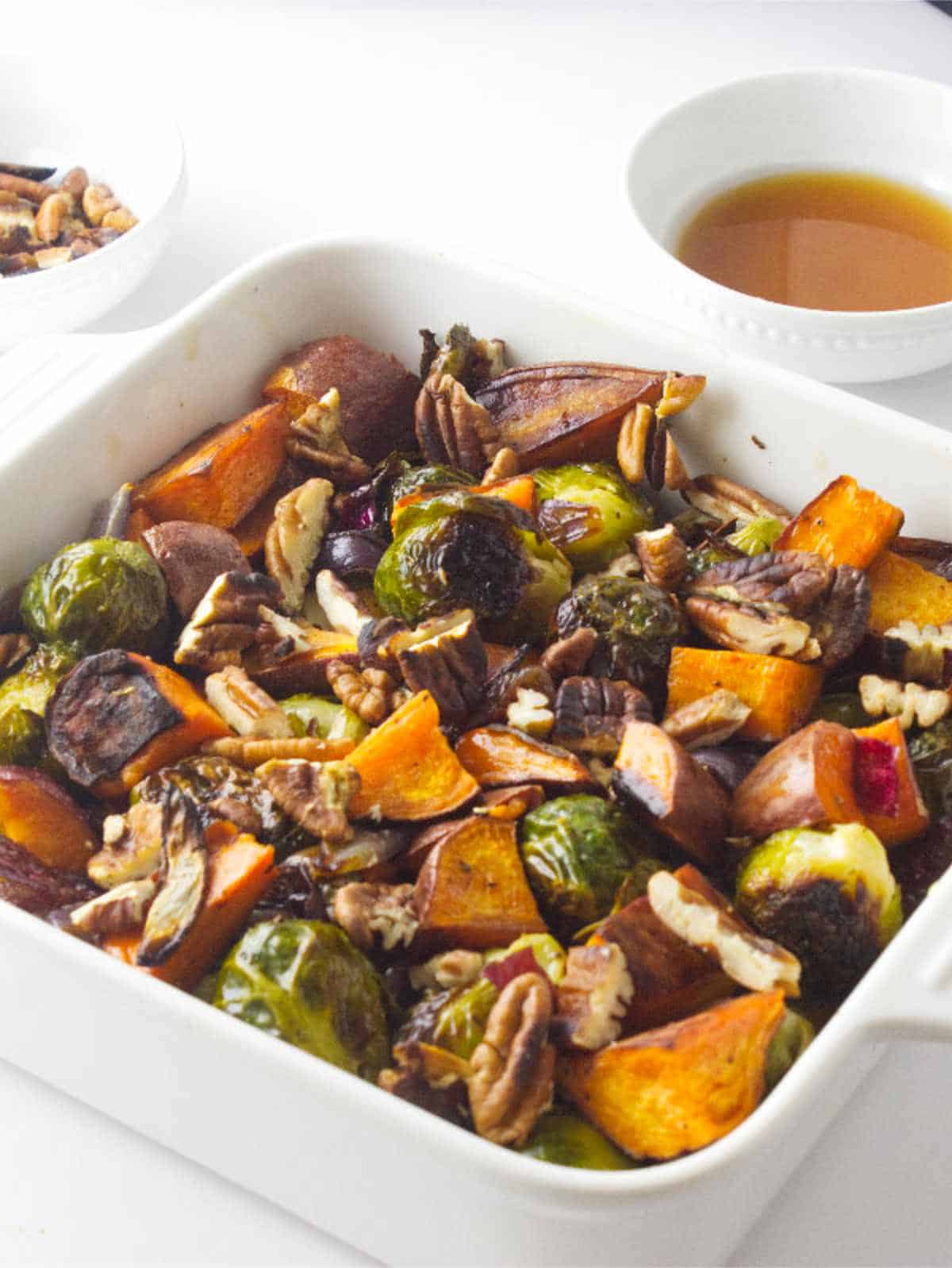 roasted brussels sprouts and sweet potatoes in a serving dish.