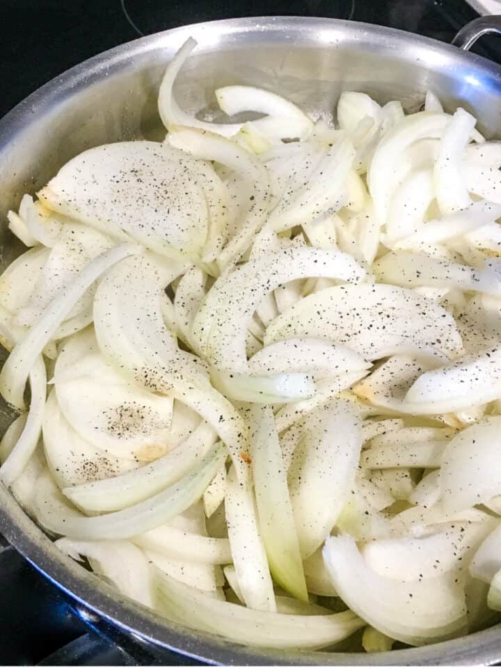 sliced onions in a skillet.