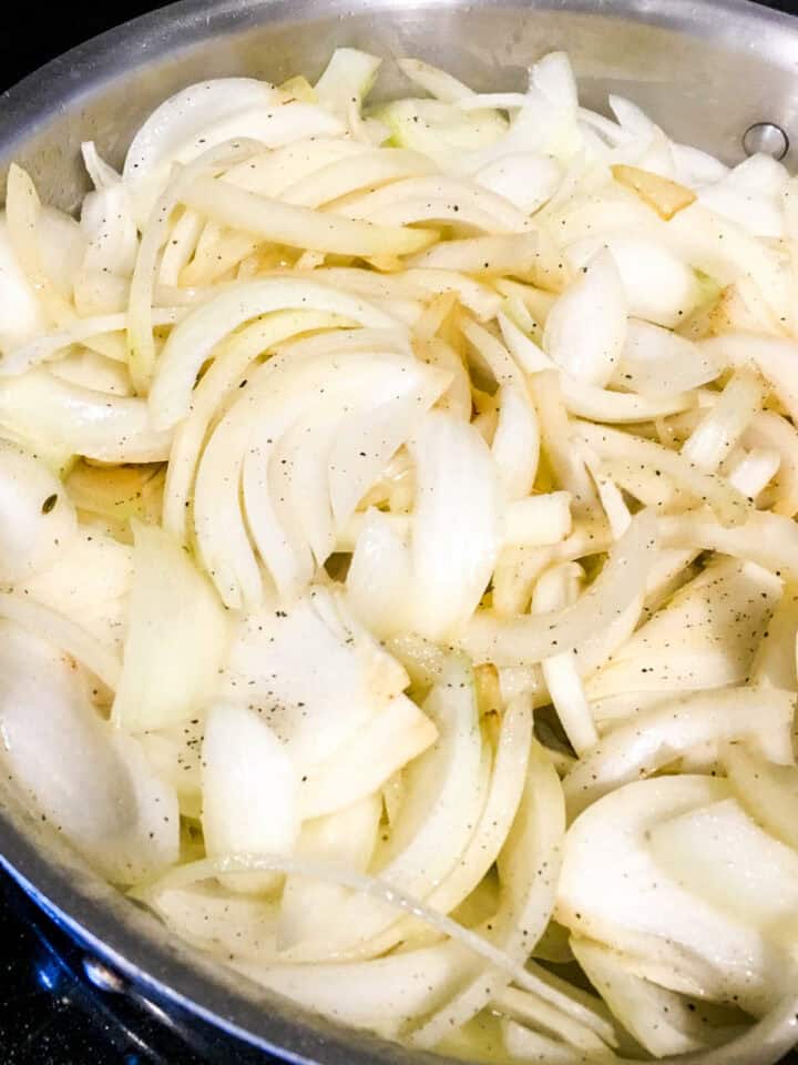 sliced onions in a skillet.