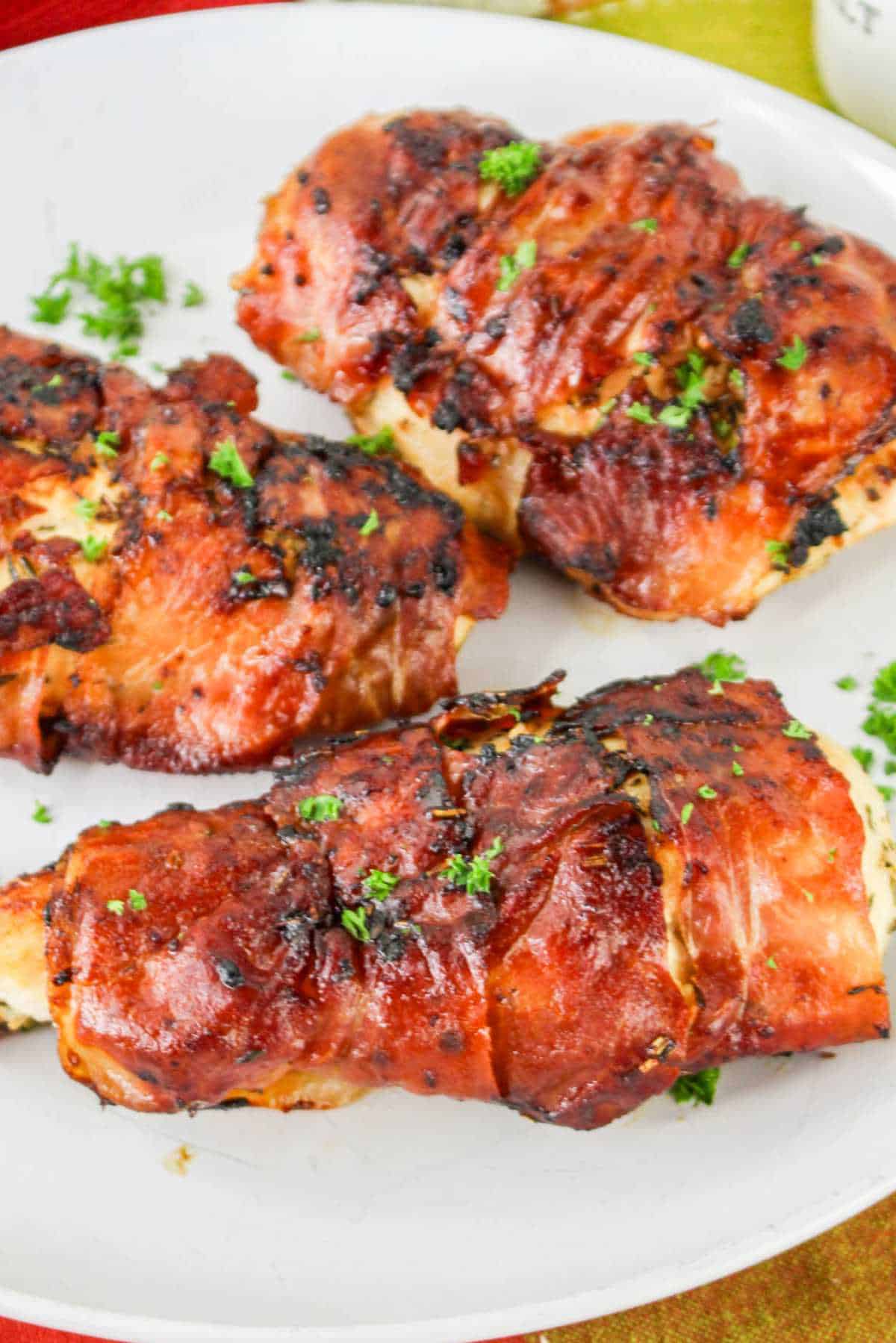 Prosciutto wrapped (chicken saltimbocca) chicken on a plate.