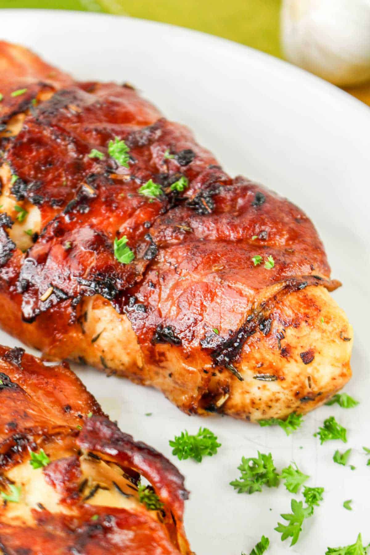 Prosciutto wrapped (chicken saltimbocca) chicken on a plate.