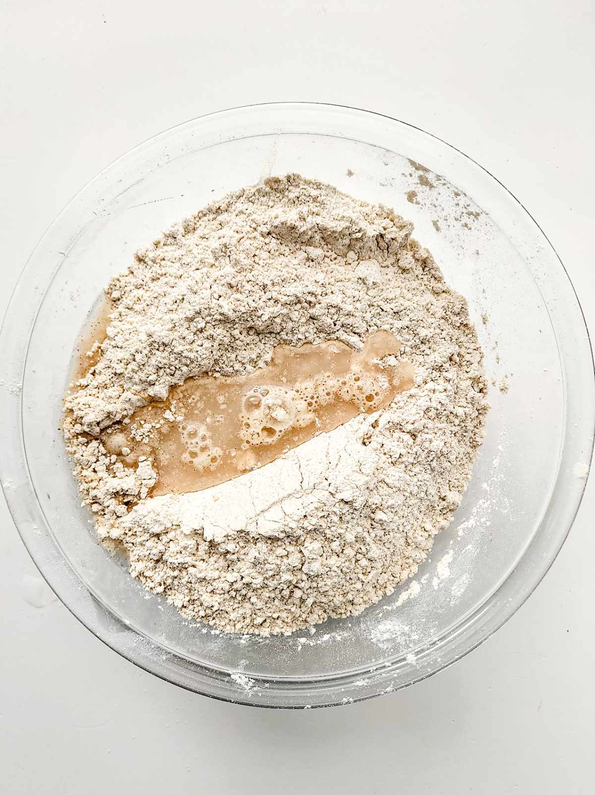 liquid added to bowl of flour, yeast, and cinnamon.