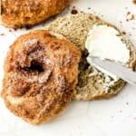cinnamon bagels with cinnamon crunch topping spread with cream cheese.