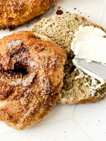 cinnamon bagels with cinnamon crunch topping spread with cream cheese.