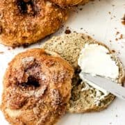 cinnamon bagels with cinnamon crunch topping spread with cream cheese.