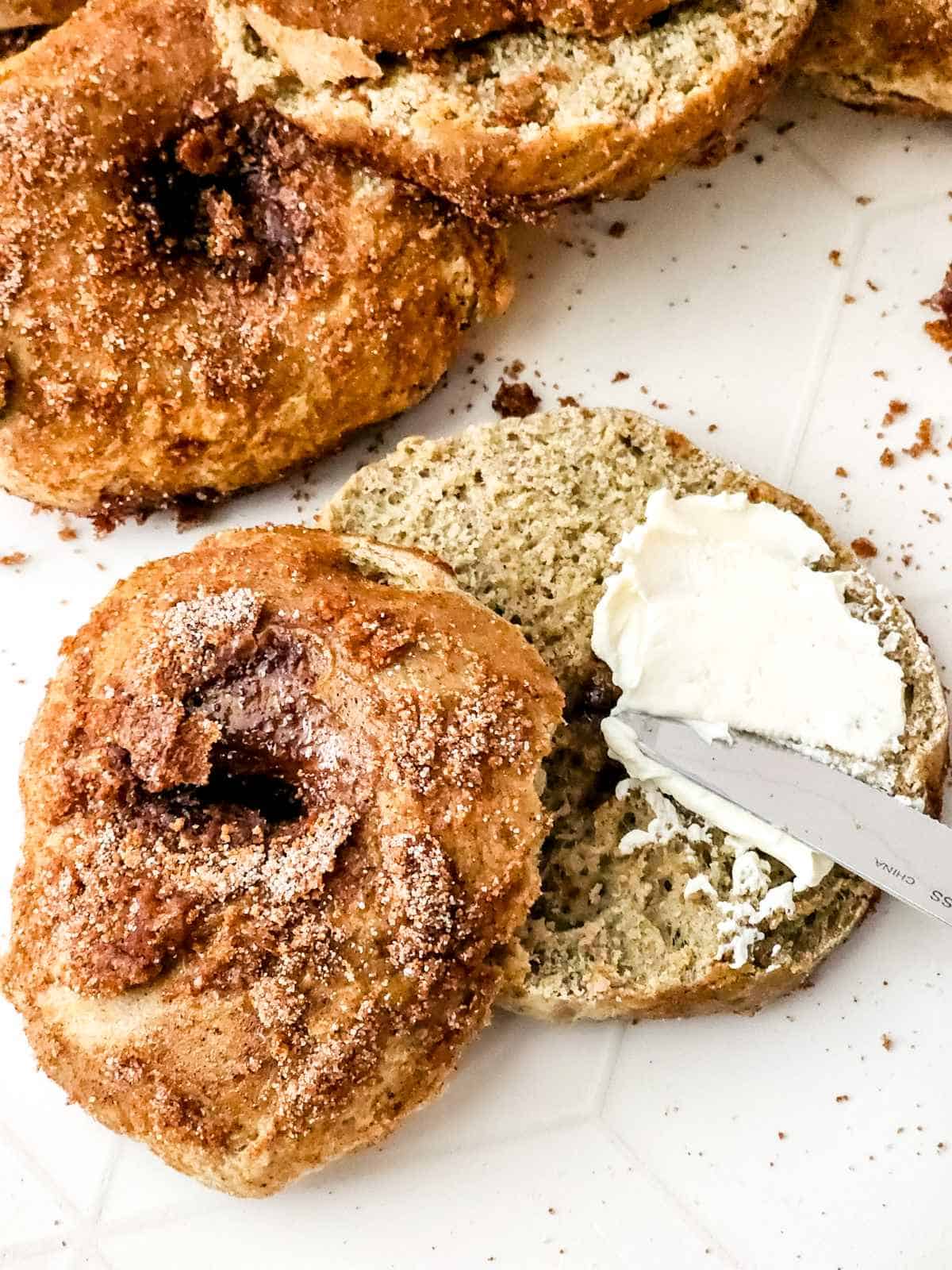 Cinnamon Bagels spread with cream cheese.