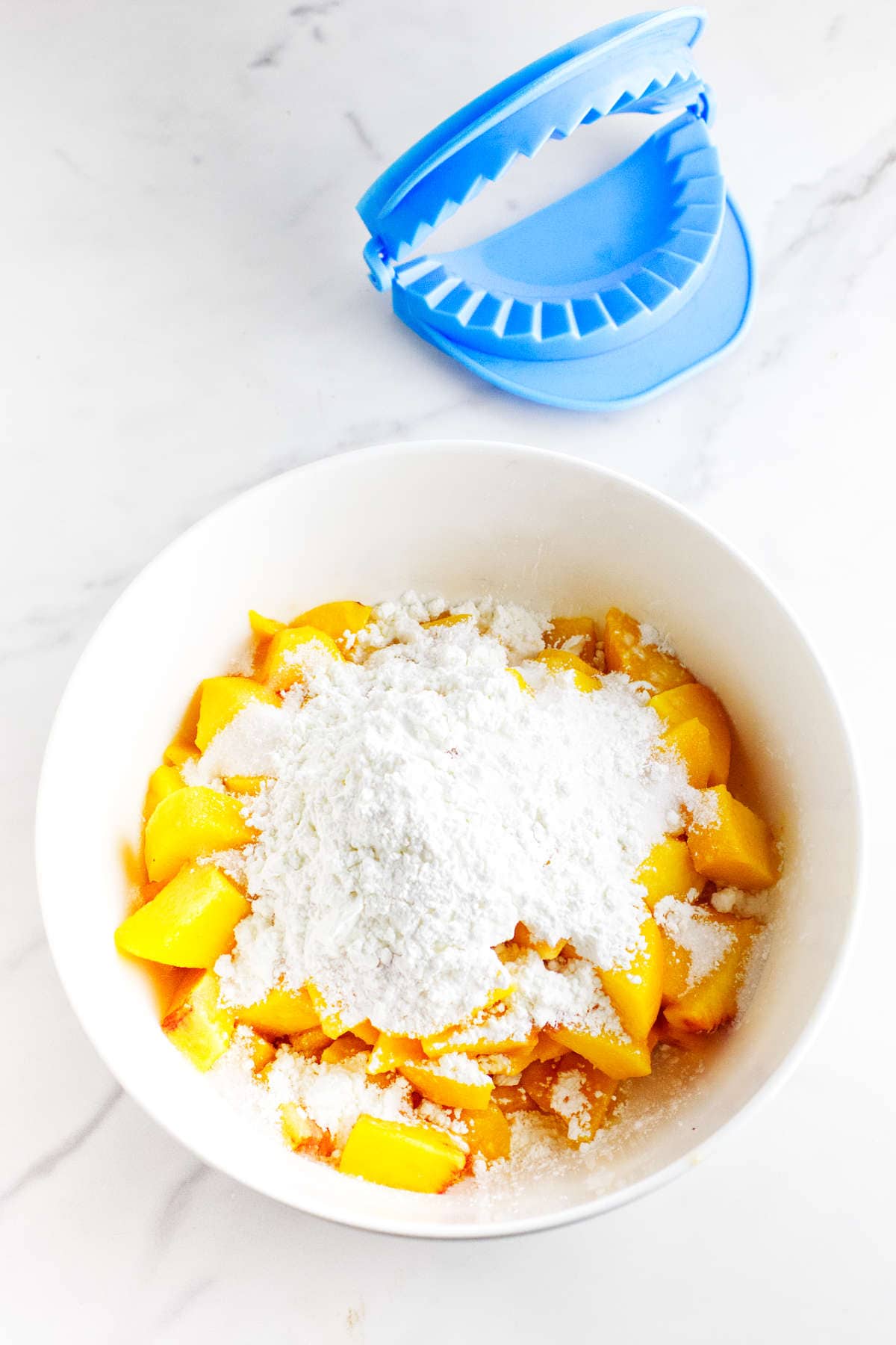 diced fresh peaches, sugar, and cornstarch in a bowl.