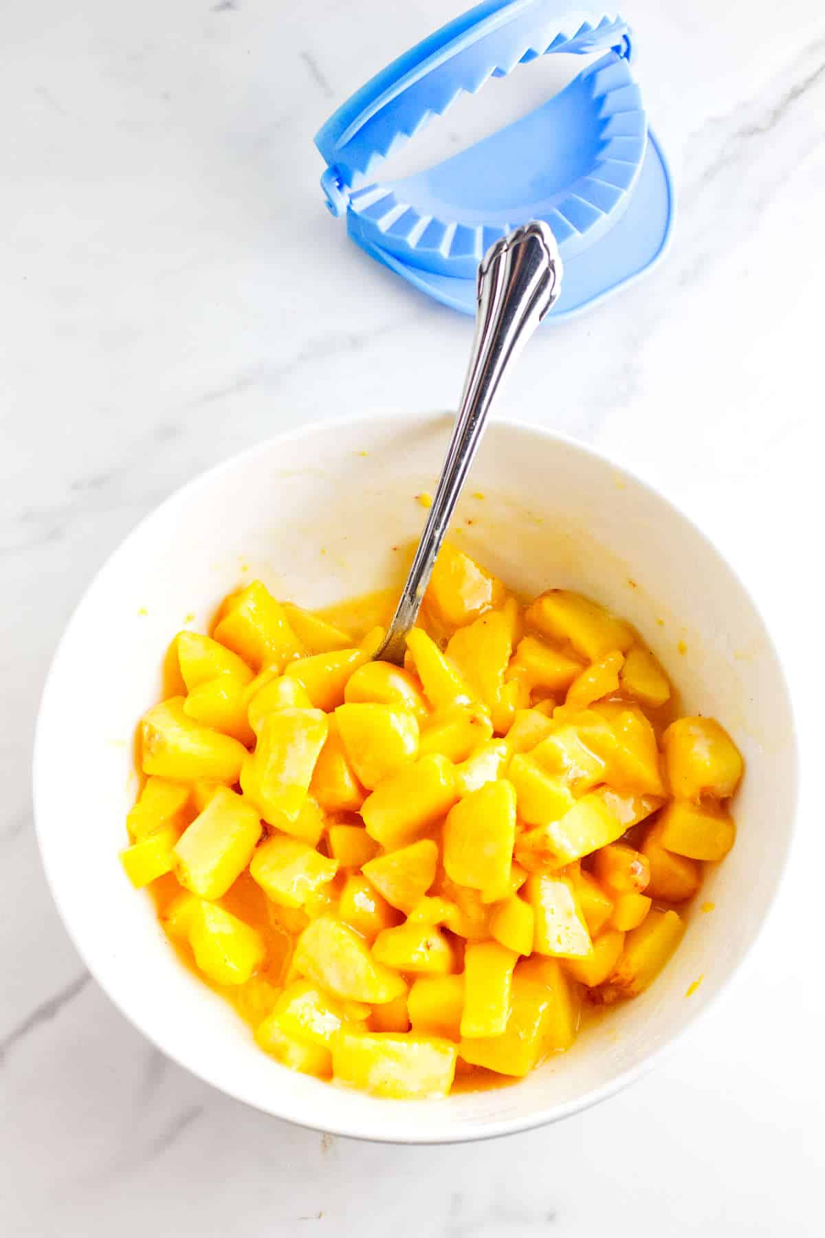 diced fresh peaches, sugar, and cornstarch in a bowl.