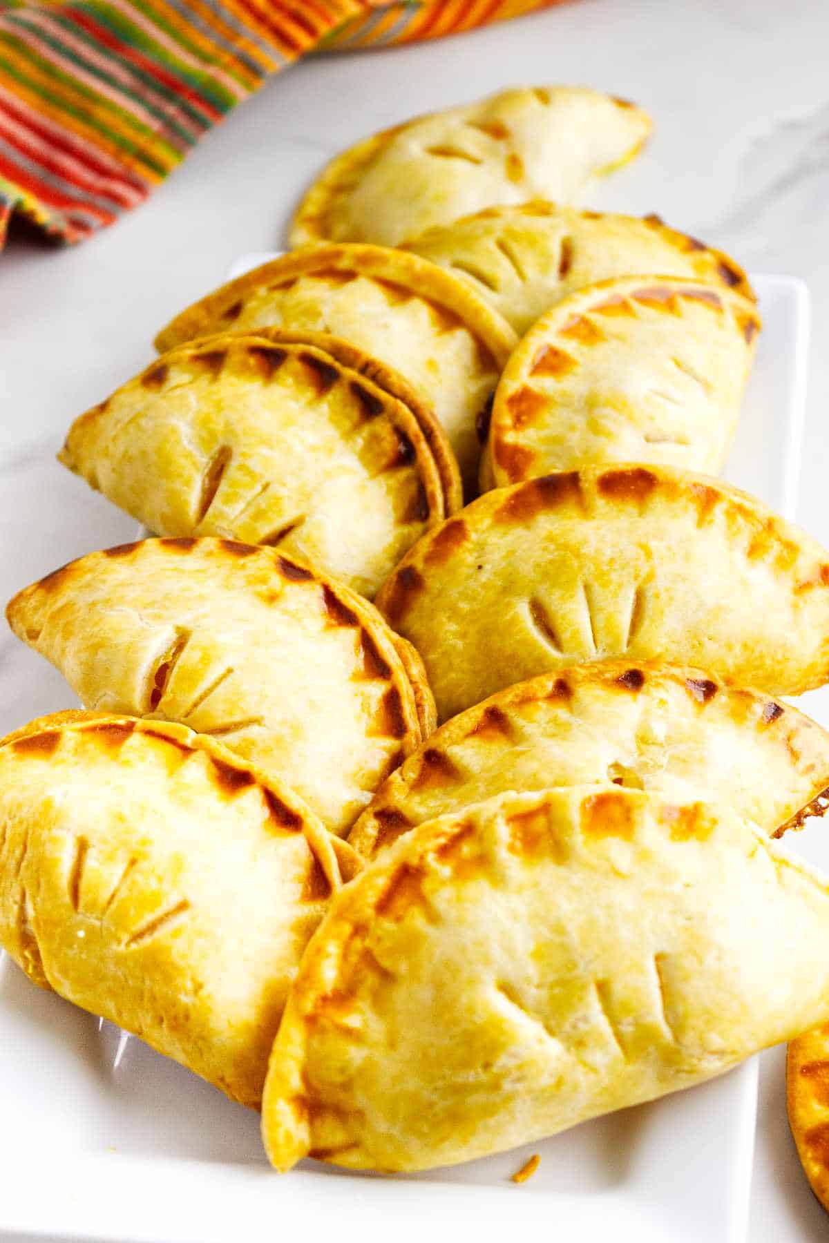 golden brown peach hand pies on a serving platter.