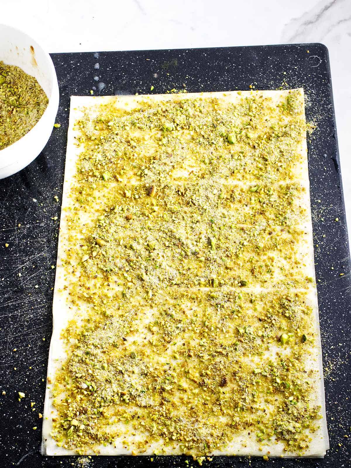 pistachio filling sprinkled over the buttered filo dough.