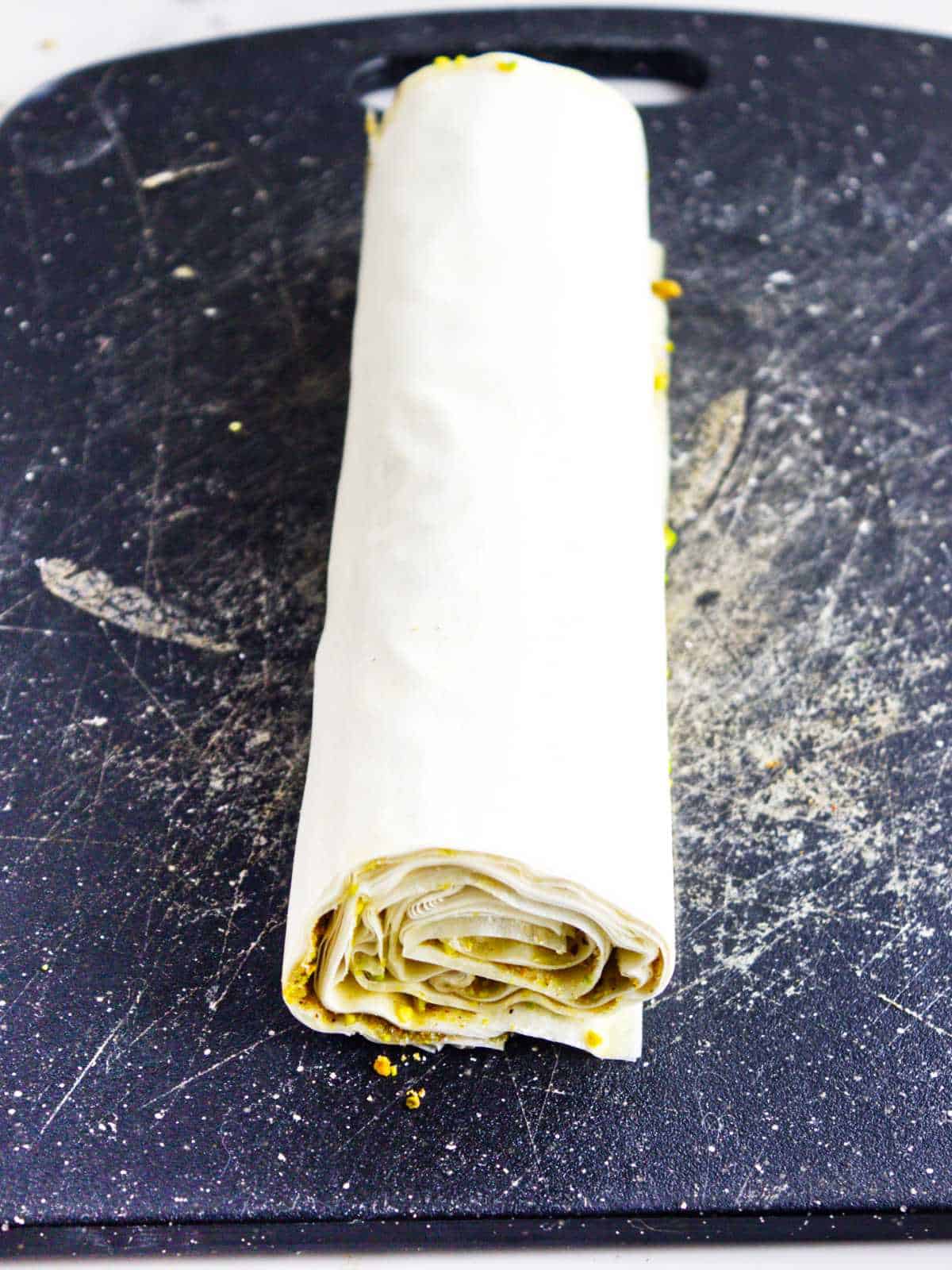 roll up the phyllo dough from the short end.