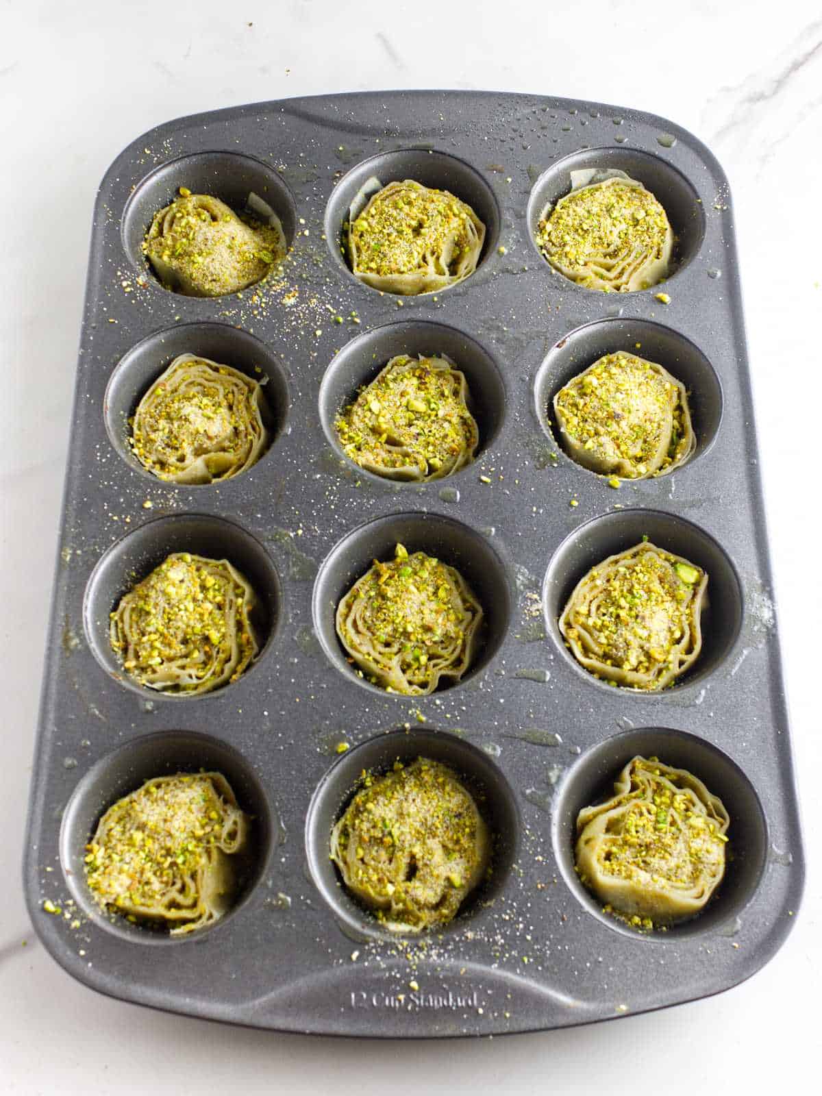 baklava pinwheels in a muffin pan.