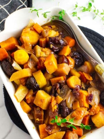 tzimmes made from rainbow carrots, orange sweet potatoes, prunes and dried fruit.