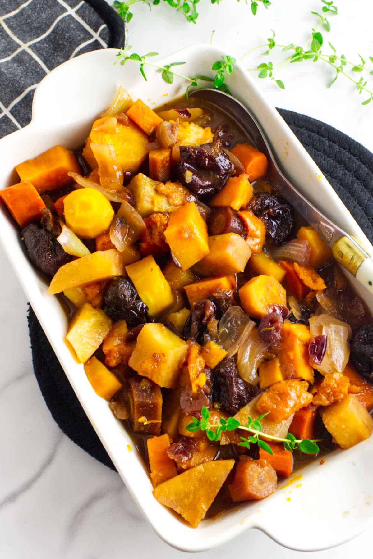 tzimmes made from rainbow carrots, orange sweet potatoes, prunes and dried fruit.