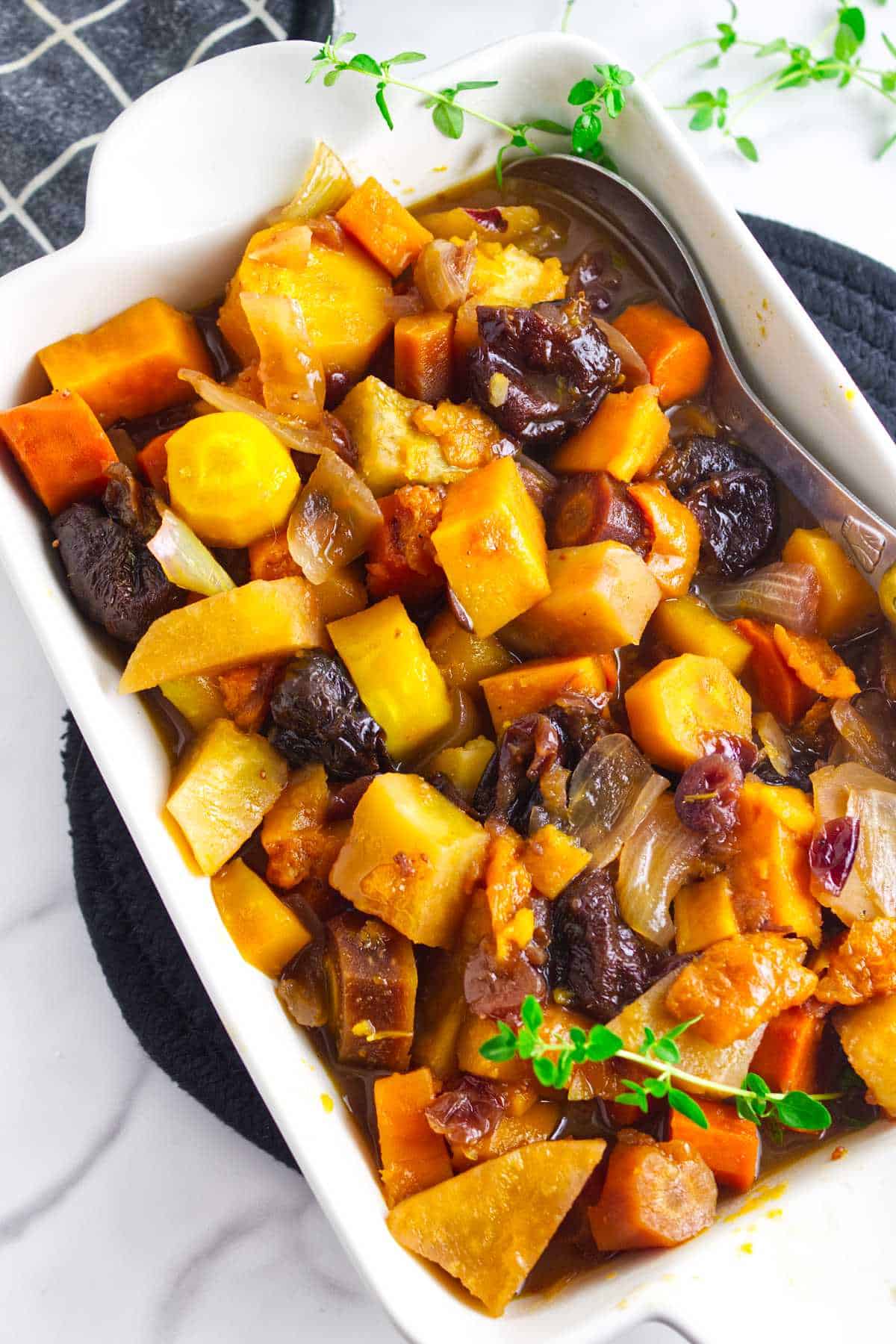 tzimmes made from rainbow carrots, orange sweet potatoes, prunes and dried fruit.