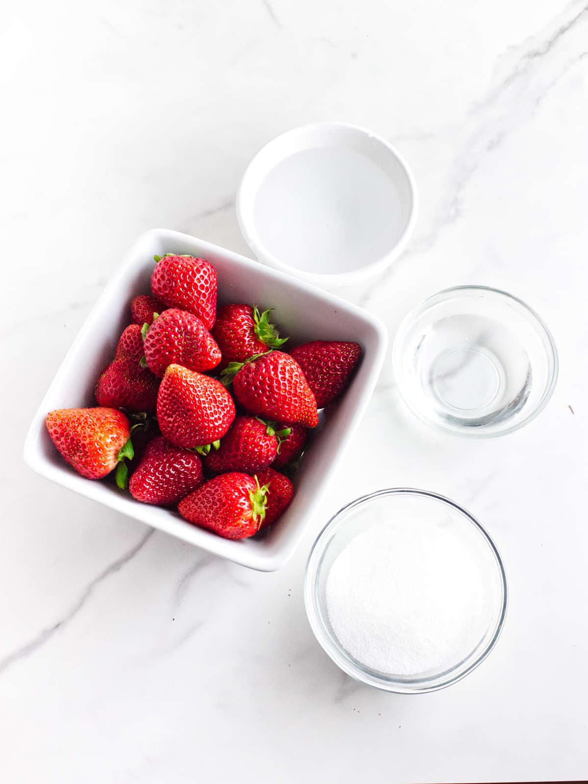 basket of strawberries, and bowls of sugar, water, and vegetable glycerin.