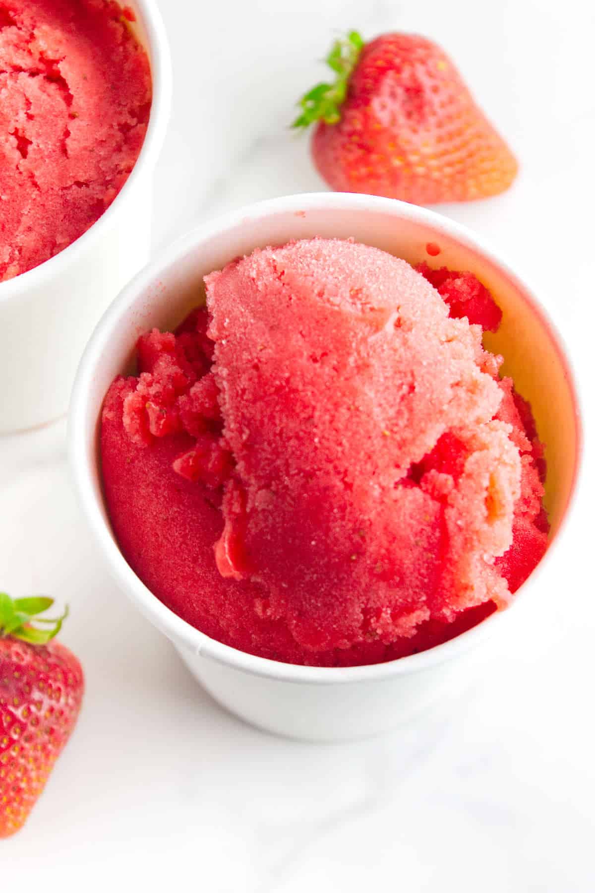 Strawberry sorbetto in ice cream storage tubs.