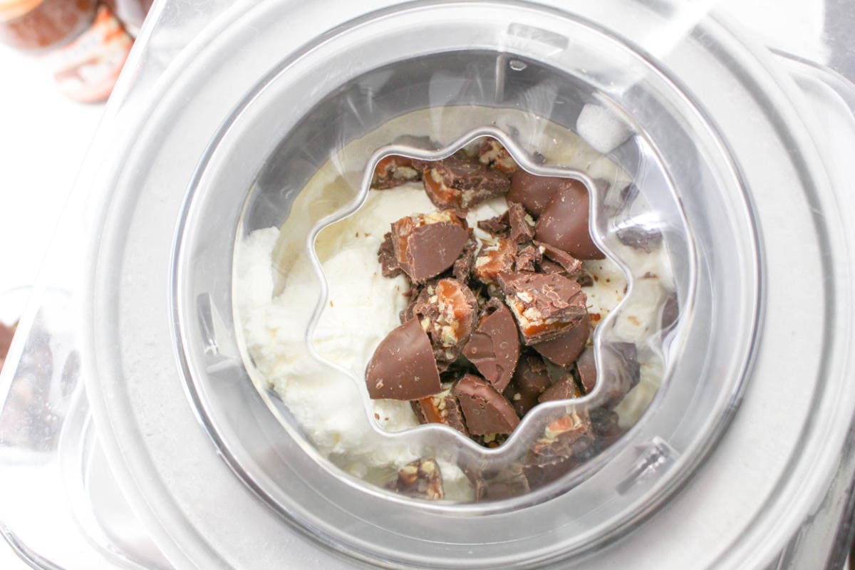 chopped turtle candies added to Cuisinart freezer drum during churning process.